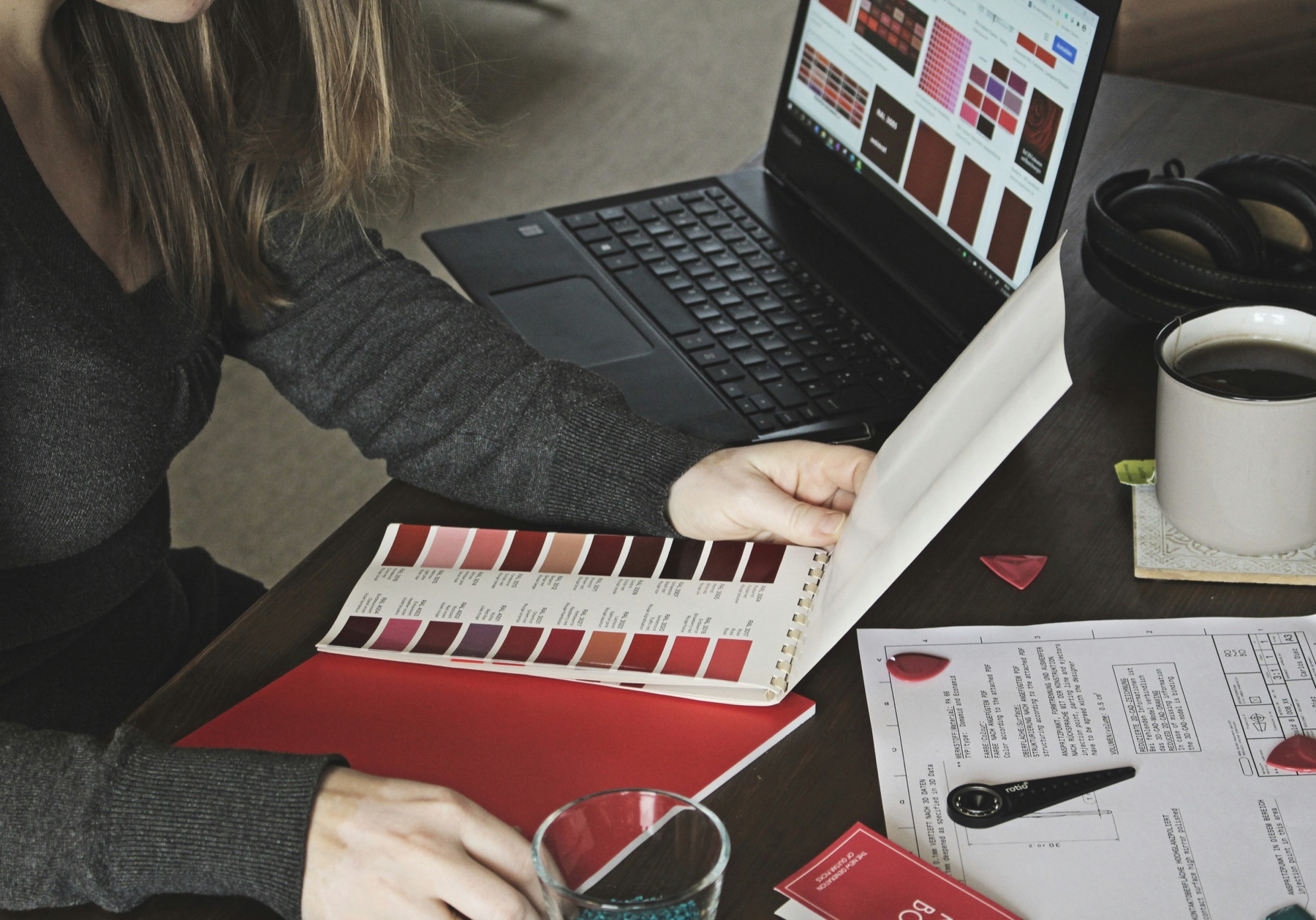 A designer comparing brand colours and applications at a desk