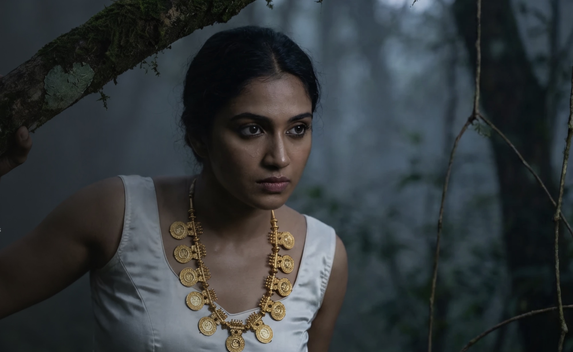 A woman wearing an antique revival gold necklace in a forest setting